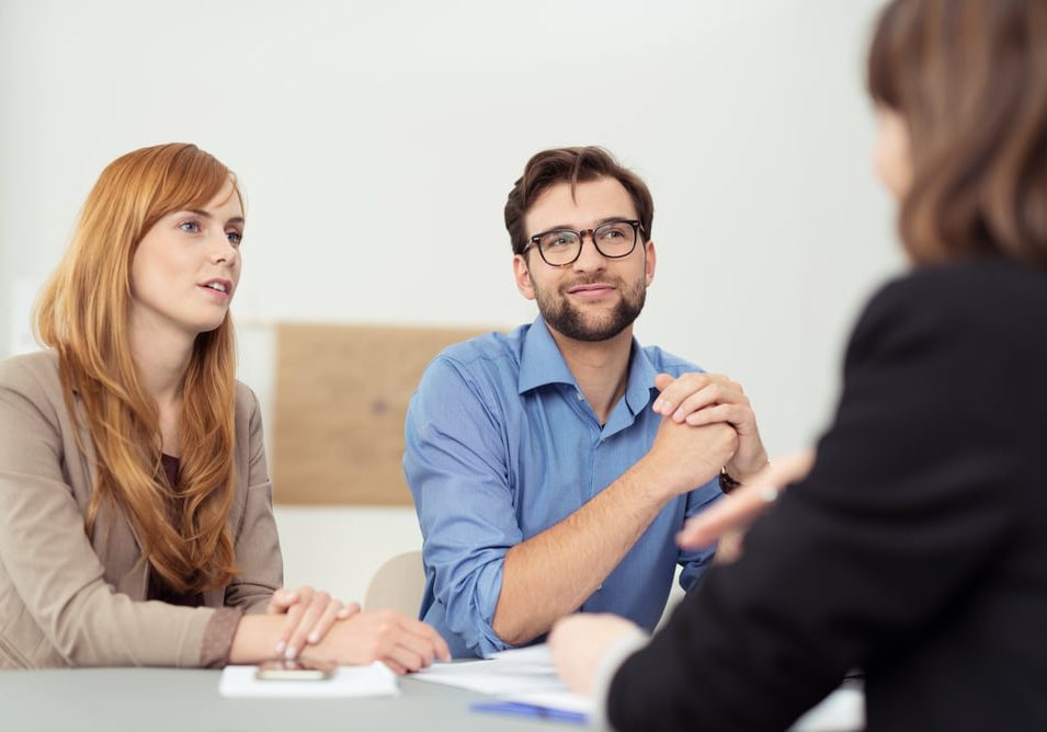Broker Having A Discussion With A Young Couple